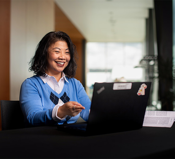 A professor and student look at a computer screen in a laboratory